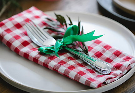 Holiday place setting with red and white checkered napkin