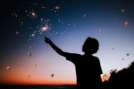 Child holding firework sparkler