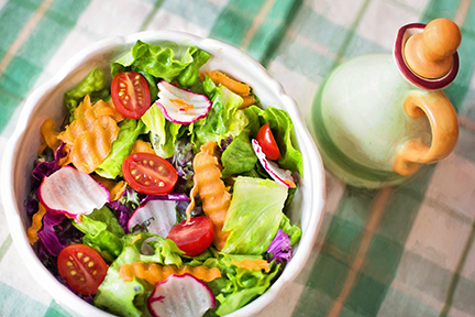 Green salad with dressing bottle